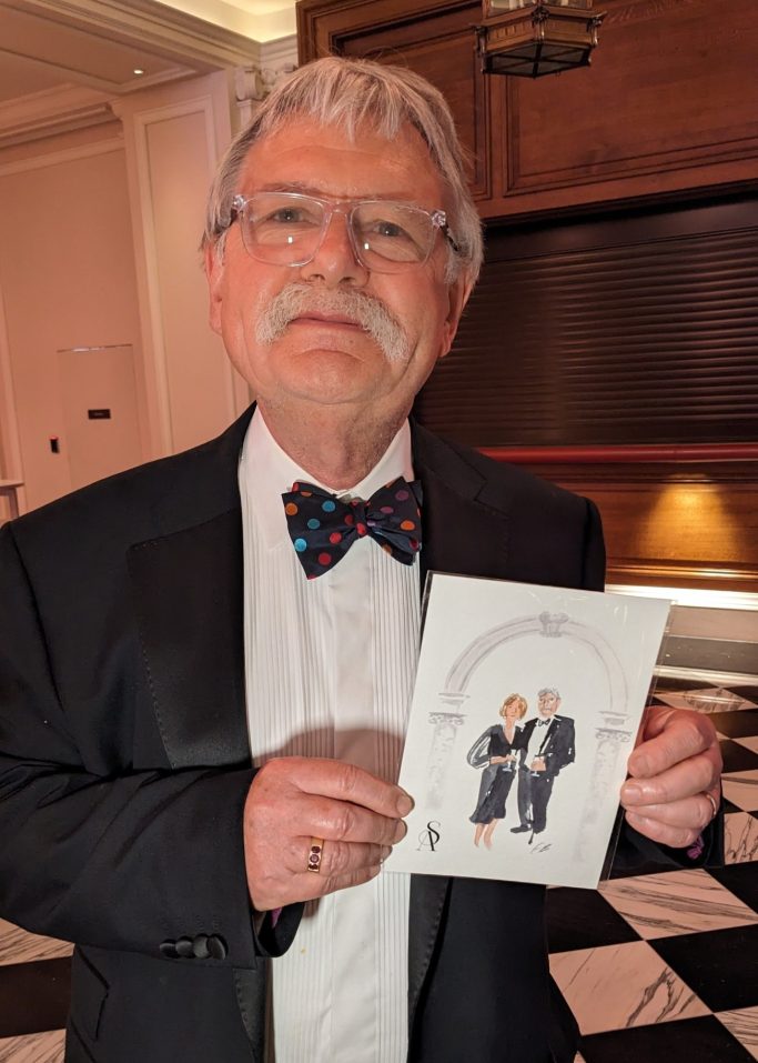man holds his live illustrated or painted portrait 
